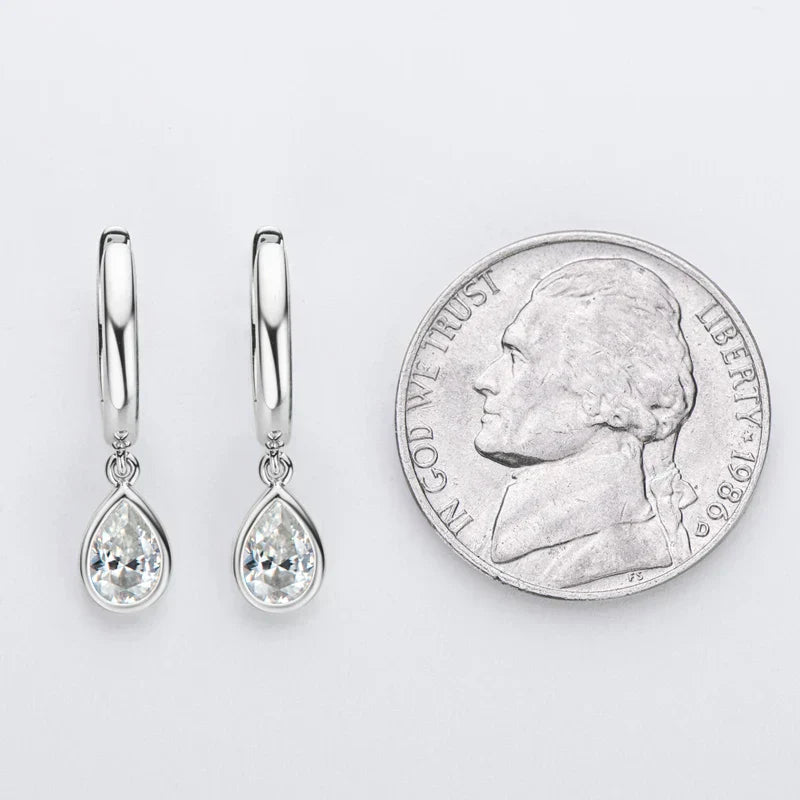 Pear cut moissanite hoop earrings in 925 sterling silver with secure closure and bright white gold finish