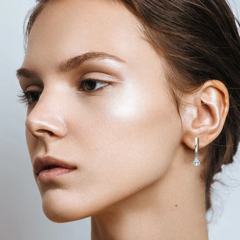 Pear Cut Moissanite hoop earrings in 925 sterling silver with teardrop-shaped stones and secure closure