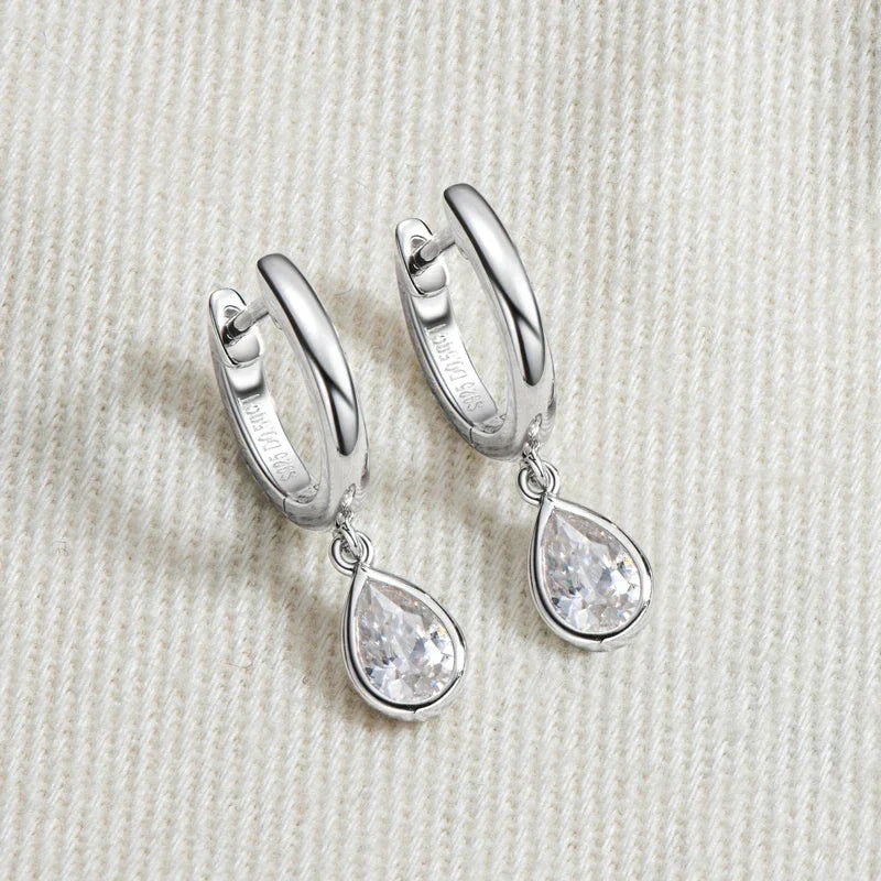 Pear cut moissanite hoop earrings in 925 sterling silver with teardrop design and secure closure
